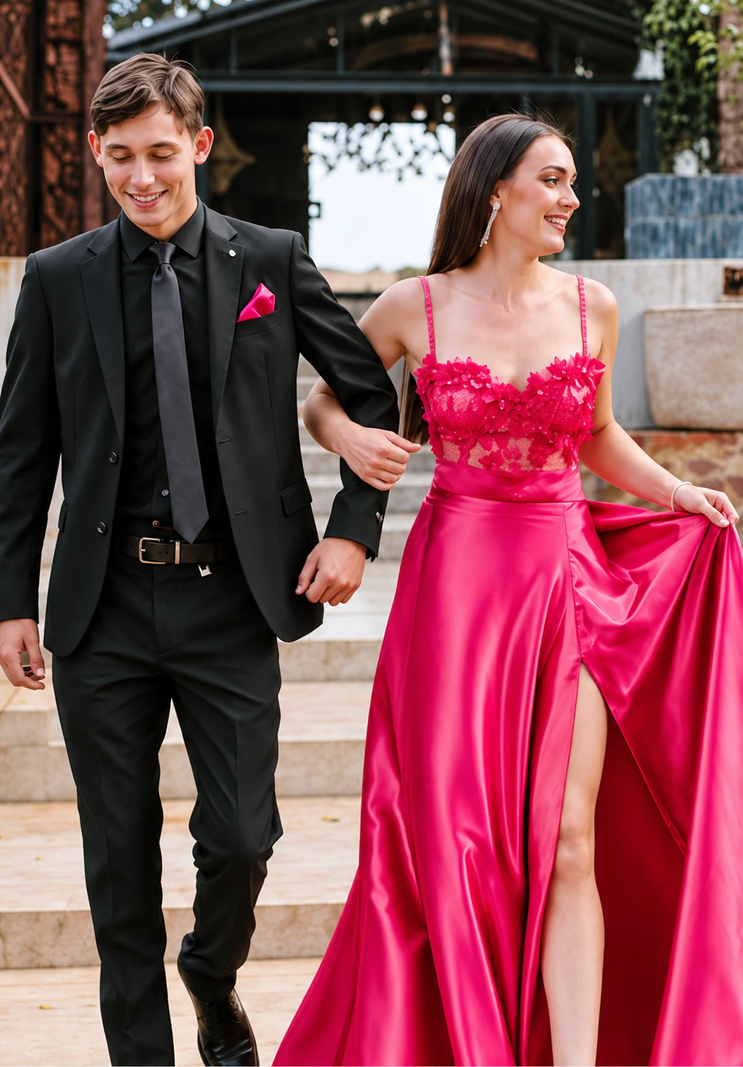 A couple in black formalwear and a pink gown